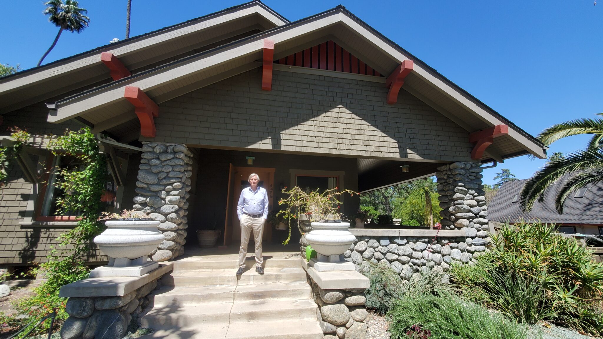 Ian standing in front of his california craftsman in downtown riverside